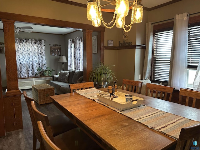 dining area with ceiling fan with notable chandelier, crown molding, wood finished floors, and ornate columns