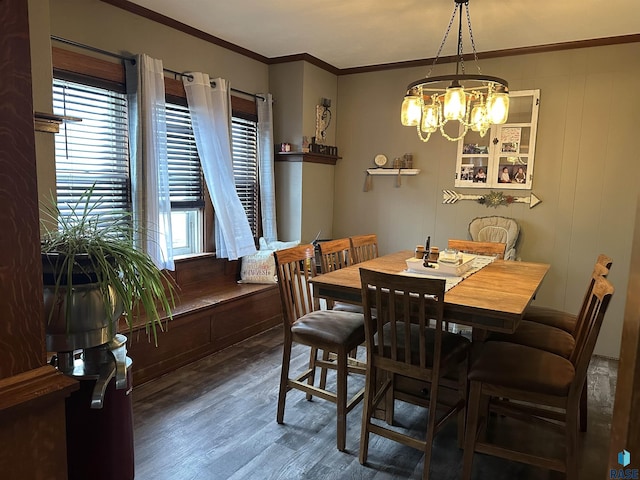 dining room with an inviting chandelier, wood finished floors, and ornamental molding