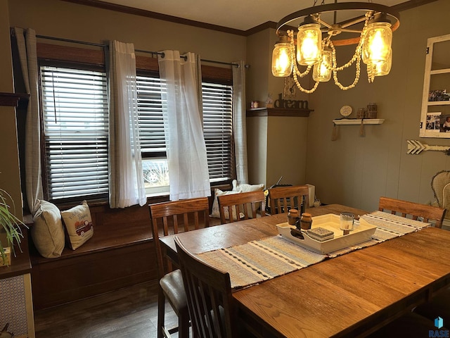 dining room with crown molding, an inviting chandelier, and wood finished floors