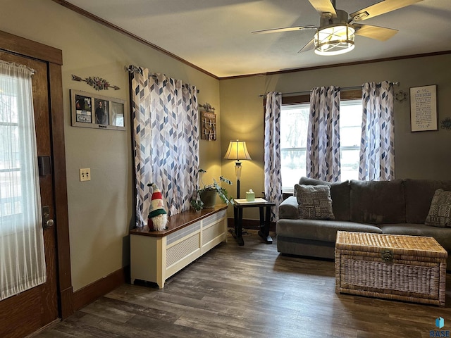 living room with crown molding, baseboards, dark wood-style flooring, and ceiling fan