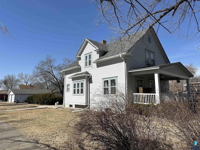 view of front facade featuring cooling unit, roof with shingles, a porch, and a chimney