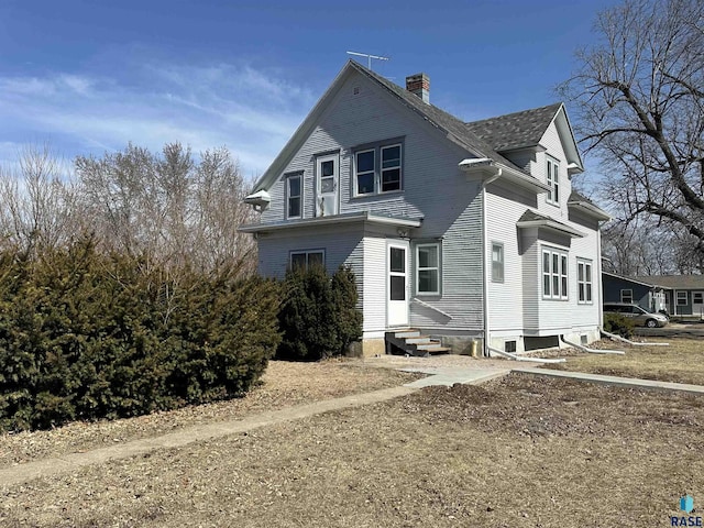 exterior space with a chimney and entry steps