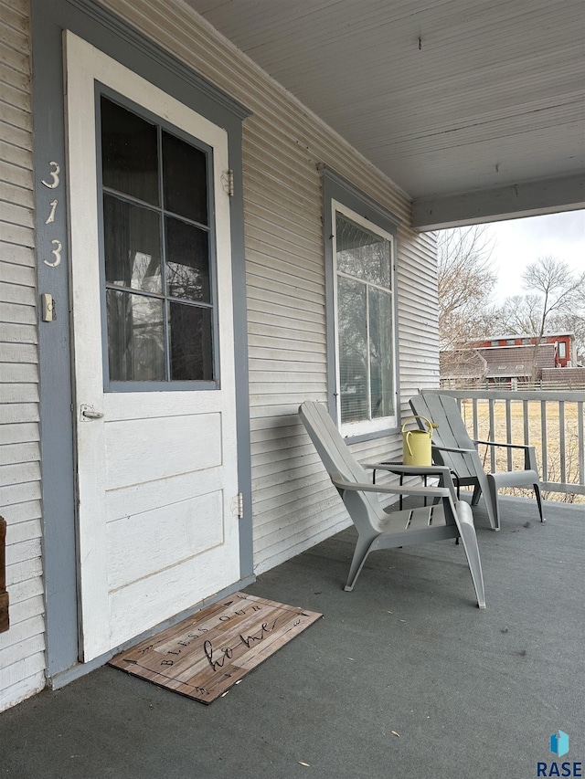 entrance to property featuring a porch