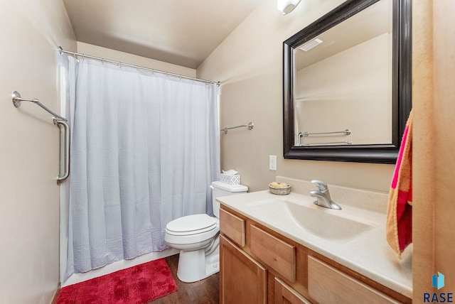 bathroom featuring curtained shower, toilet, and vanity