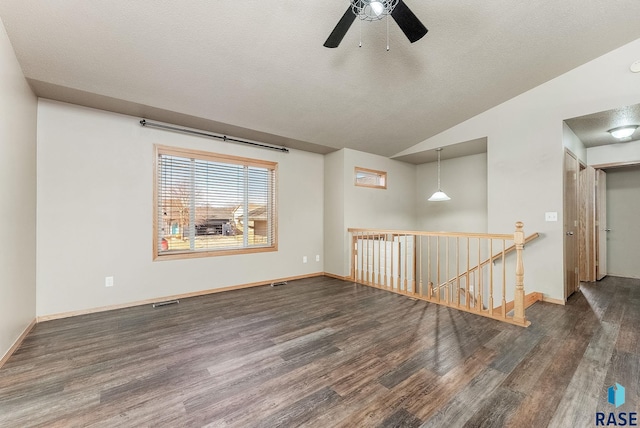 unfurnished room featuring a textured ceiling, wood finished floors, ceiling fan, and vaulted ceiling