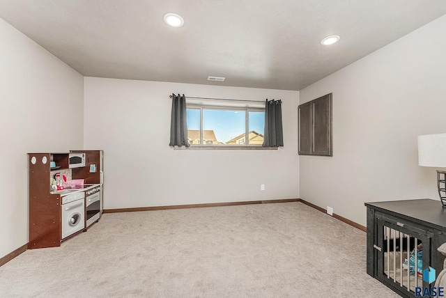 interior space with recessed lighting, baseboards, light carpet, and visible vents