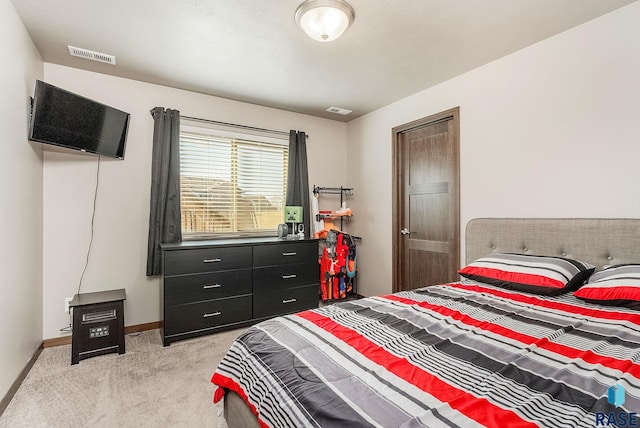 bedroom with baseboards, light carpet, and visible vents