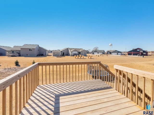 deck with a yard and a residential view