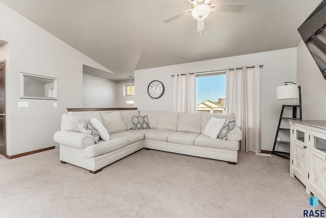 living room with a ceiling fan, lofted ceiling, light colored carpet, and baseboards