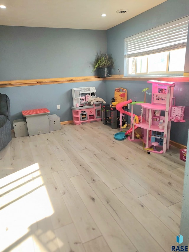 playroom with recessed lighting, wood finished floors, and visible vents