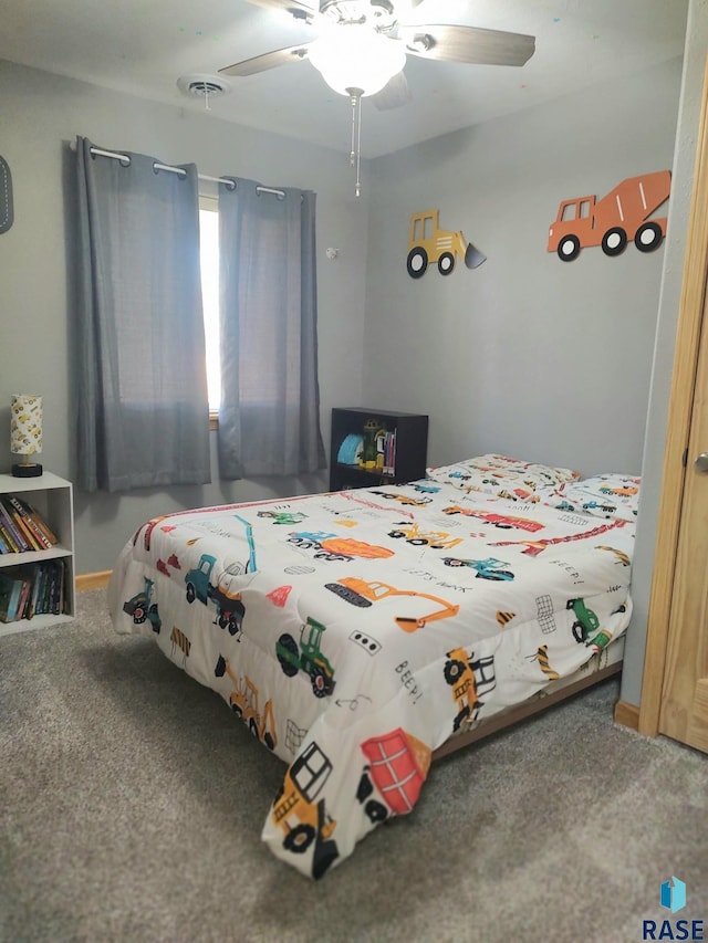 carpeted bedroom with visible vents and a ceiling fan