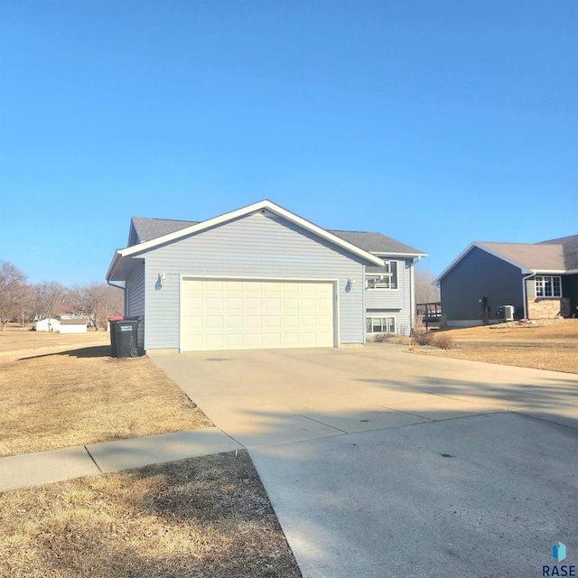 view of front of house with concrete driveway and an attached garage