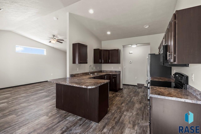 kitchen featuring dark brown cabinetry, lofted ceiling, a peninsula, dark wood-style floors, and a ceiling fan