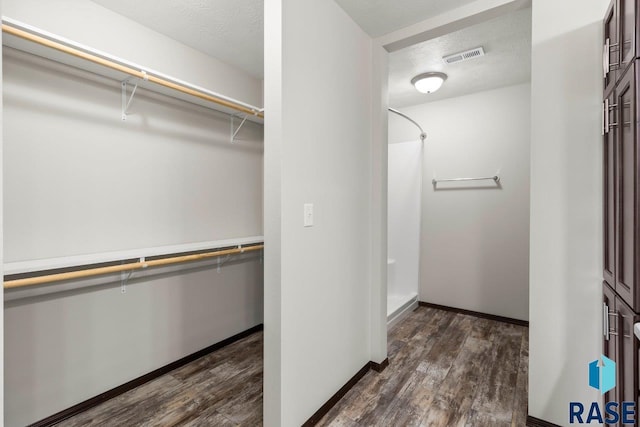 interior space with visible vents and dark wood-style flooring