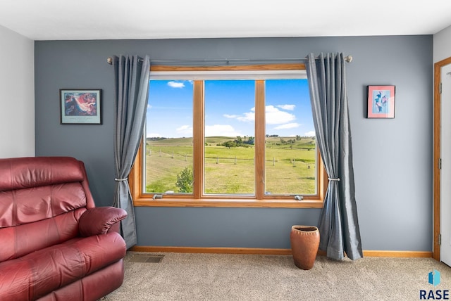 sitting room featuring visible vents, carpet flooring, and baseboards