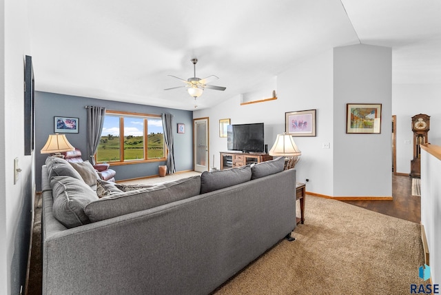 living room with vaulted ceiling, a ceiling fan, and baseboards