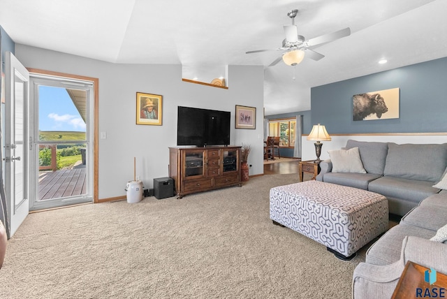 carpeted living room with baseboards, lofted ceiling, and ceiling fan