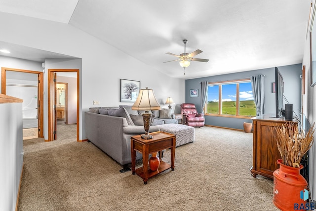 living area featuring a ceiling fan, lofted ceiling, carpet, and baseboards