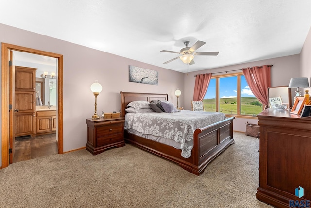 carpeted bedroom featuring baseboards, ceiling fan, and ensuite bathroom
