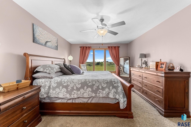 bedroom with access to exterior, light colored carpet, and a ceiling fan