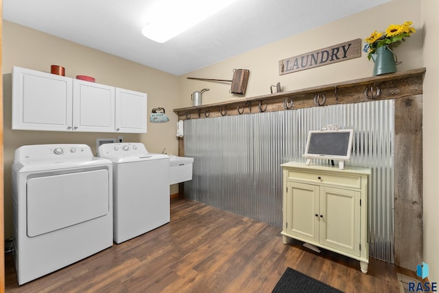 laundry area featuring washer and dryer, cabinet space, dark wood-type flooring, and a sink