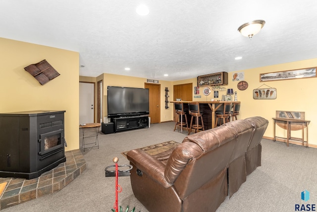 living area featuring a bar, carpet flooring, recessed lighting, and a textured ceiling