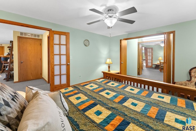 bedroom featuring carpet flooring, visible vents, a ceiling fan, and baseboards