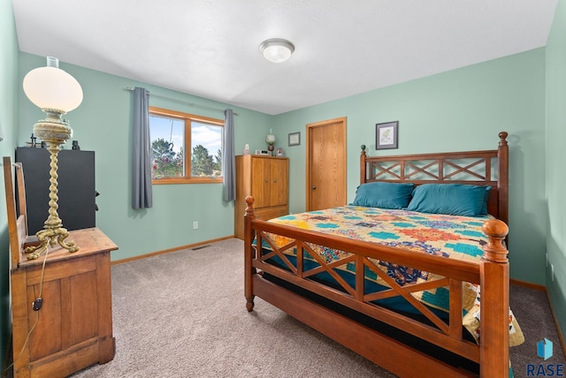 carpeted bedroom featuring visible vents and baseboards