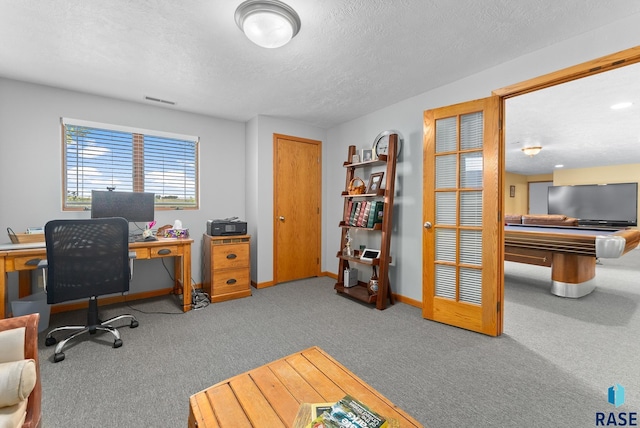 carpeted office space featuring visible vents, pool table, a textured ceiling, and baseboards