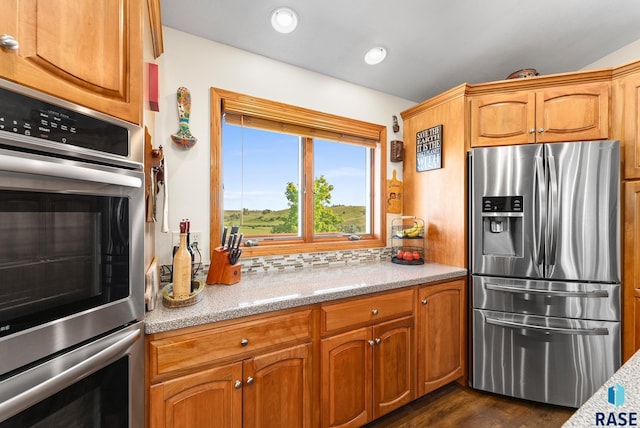 kitchen with tasteful backsplash, dark wood-type flooring, recessed lighting, brown cabinets, and stainless steel appliances