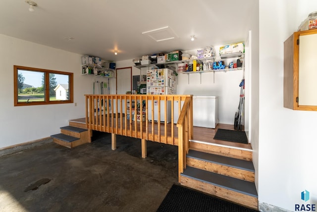 interior space featuring attic access and concrete floors