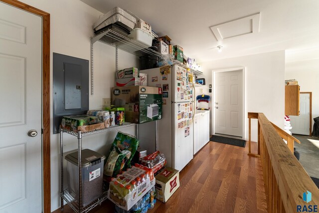 kitchen featuring electric panel, wood counters, wood finished floors, and freestanding refrigerator