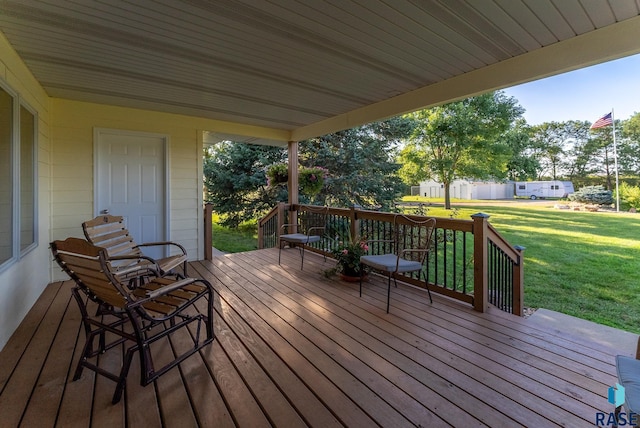 wooden deck featuring a lawn