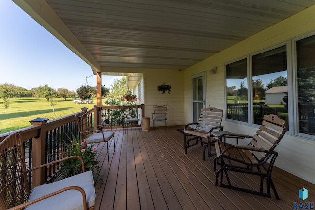 wooden terrace with a lawn