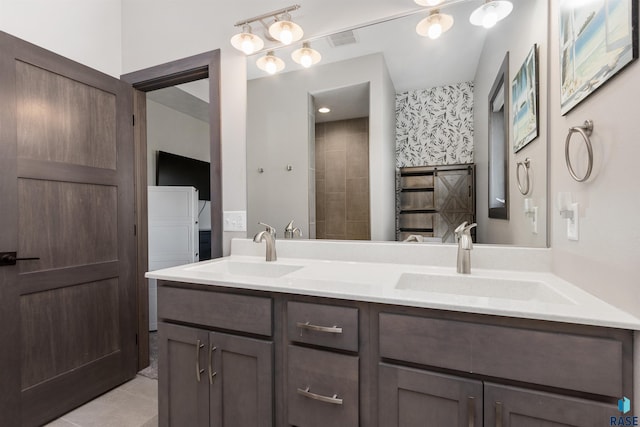 full bath with double vanity, visible vents, tile patterned floors, and a sink