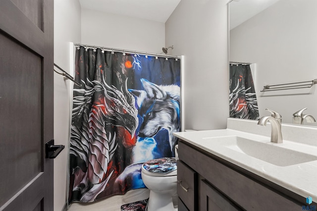 bathroom with vanity, curtained shower, and toilet