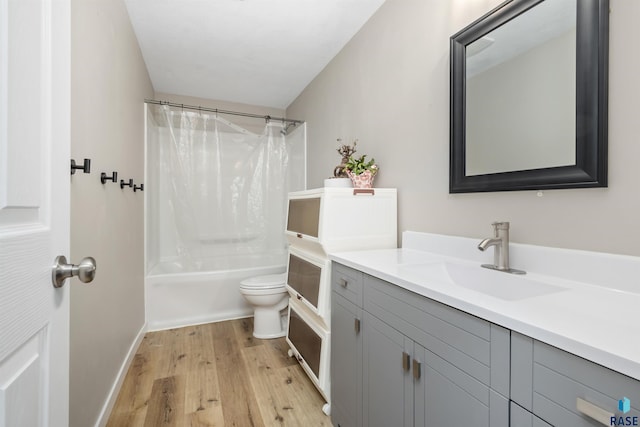 bathroom featuring shower / bathtub combination with curtain, toilet, wood finished floors, baseboards, and vanity