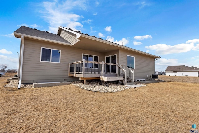 back of house with a wooden deck and a yard