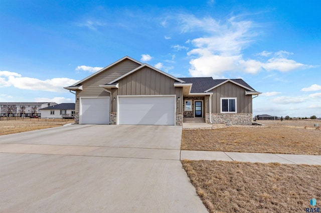 single story home featuring stone siding, board and batten siding, concrete driveway, and an attached garage