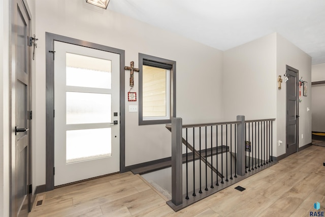 entrance foyer featuring plenty of natural light, wood finished floors, and baseboards