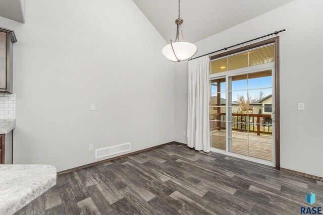 204 E 81st Pl, Sioux Falls, SD 57108 - unfurnished dining area with dark wood-style floors, visible vents, baseboards, and vaulted ceiling