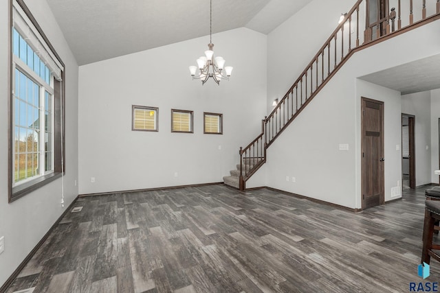 204 E 81st Pl, Sioux Falls, SD 57108 - unfurnished living room with high vaulted ceiling, wood finished floors, and stairs