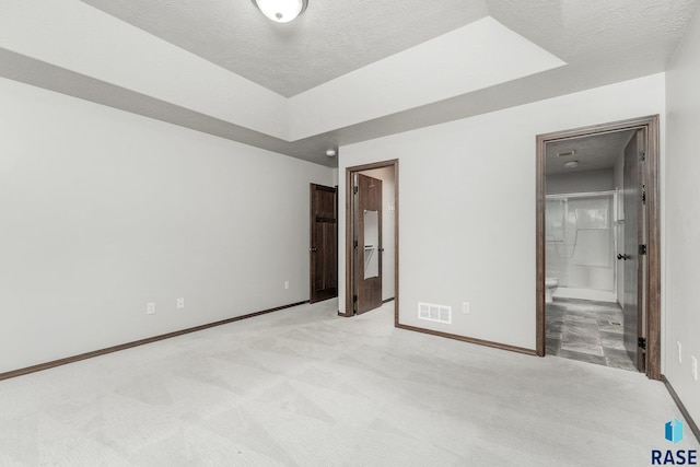 204 E 81st Pl, Sioux Falls, SD 57108 - unfurnished bedroom featuring visible vents, connected bathroom, baseboards, carpet floors, and a textured ceiling