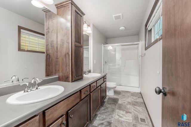 204 E 81st Pl, Sioux Falls, SD 57108 - bathroom featuring visible vents, a stall shower, and a sink
