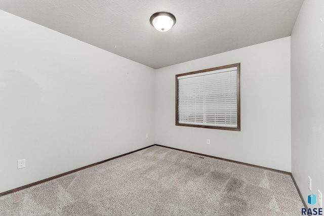 204 E 81st Pl, Sioux Falls, SD 57108 - carpeted spare room with baseboards and a textured ceiling