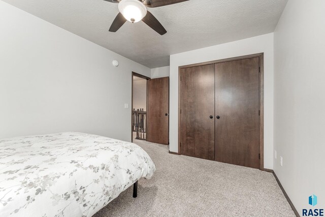 204 E 81st Pl, Sioux Falls, SD 57108 - bedroom with baseboards, ceiling fan, a closet, a textured ceiling, and carpet flooring