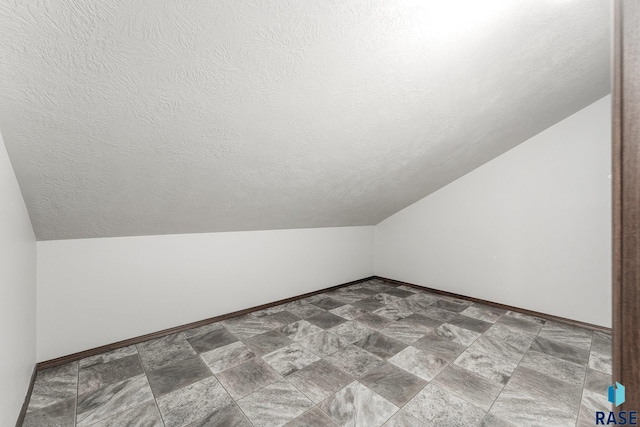 204 E 81st Pl, Sioux Falls, SD 57108 - additional living space featuring baseboards, a textured ceiling, and vaulted ceiling