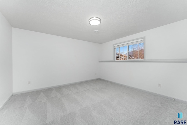 204 E 81st Pl, Sioux Falls, SD 57108 - carpeted empty room featuring baseboards and a textured ceiling