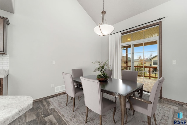 204 E 81st Pl, Sioux Falls, SD 57108 - dining space with visible vents, baseboards, high vaulted ceiling, and wood finished floors