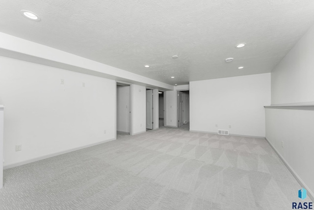 204 E 81st Pl, Sioux Falls, SD 57108 - below grade area with visible vents, baseboards, recessed lighting, a textured ceiling, and light carpet